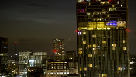 MANCHESTER,-UK---2021:-Close-up-artistic-and-iconic-view-of-the-Hilton-Hotel-in-Manchester-UK-at-Night-Time-Lapse