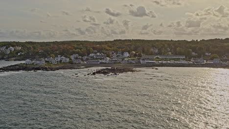 Ogunquit-Maine-Aerial-v3-pan-shot-of-coastal-homes-and-rocky-shores-at-oarweed-and-perkins-cove-with-shimmering-sunlight-reflection-on-water-surface---Shot-with-Inspire-2,-X7-camera---October-2021