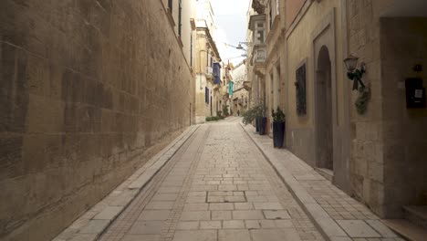 Long-Narrow-Empty-Yellow-Stone-Street-with-Old-Historic-Houses-in-Birgu