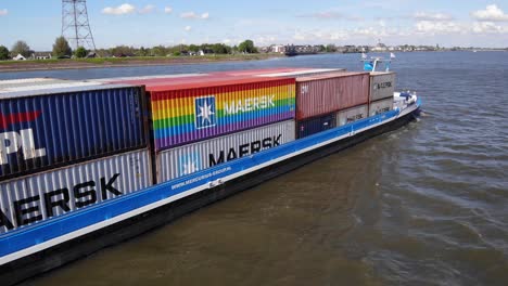 Inland-Barge-With-Stack-Of-Intermodal-Containers-Sailing-Across-Ther-River-Near-Kinderdijk,-Netherlands