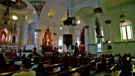 Church-interior-with-churchgoers-at-the-Molo-Church-in-Iloilo-City,-Philippines