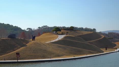 Korean-Travelers-Walking-on-Spiral-Trails-of-Haeryeong-Hill-by-the-Lake-in-Suncheonman-Bay-National-Garden,-Suncheon-South-Korea