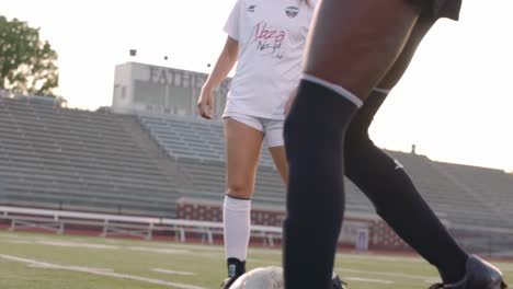 A-woman-soccer-player-dribbles-the-ball-and-passes-it-to-her-opponent-in-a-scrimmage