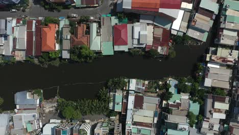 Aerial-top-down-pull-out-shot-over-high-density-suburban-area-with-small-canal