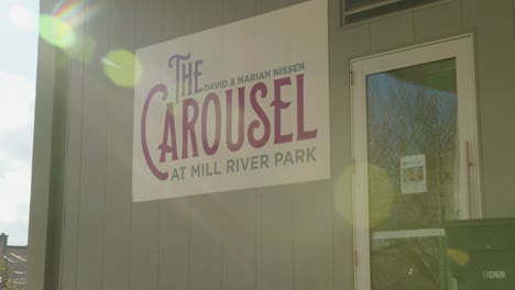 Wide-of-a-Sign-for-The-Carousel-at-Mill-River-Park-in-Stamford,-Connecticut