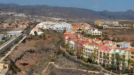 Hilly-landscape-of-Tenerife-island-with-beautiful-colorful-houses,-aerial-drone-view