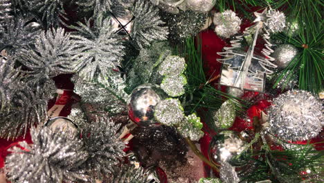 Frosted-silver-and-green-christmas-tree-decorations-being-sold-in-a-store