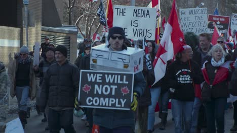 Man-with-truck-costume-marching-in-crowd-Calgary-protest-4th-March-2022