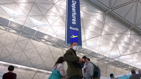 Passengers-are-seen-outside-the-departure-hall-at-Chek-Lap-Kok-International-Airport-in-Hong-Kong,-China