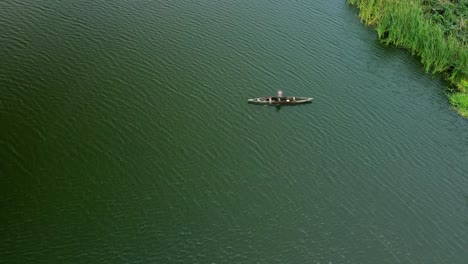 Victoria-Island-Lagos,-Nigeria---15-March-2022:-Drone-view-of-a-fisherman-on-a-fishing-boat-in-Kuramo-waters