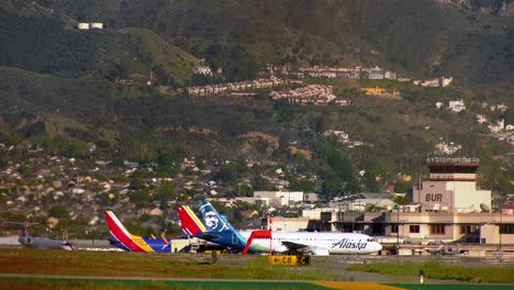 Plane-moving-at-the-Burbank-Airport,-golden-hour-in-Los-Angeles,-USA---static-view