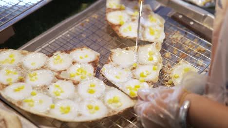 Portioning-and-Cutting-Traditional-Thai-Street-Food-Desert-Khanom-Krok-with-Corn-Filling,-Coconut-and-Rice-Flour-Pancakes