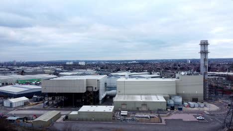 An-aerial-view-moves-towards-the-Enfield-gas-fired-power-station-and-the-surrounding-cityscape-on-a-dull-and-cloudy-day