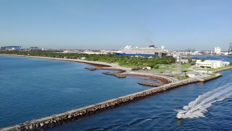 Aerial-view-of-a-landscape-of-dockyard-and-port-with-cruise-ship-docked-video-background-|-Drone-shot-video-of-a-landscape-near-a-beach-coastline-video-bacground-in-4K