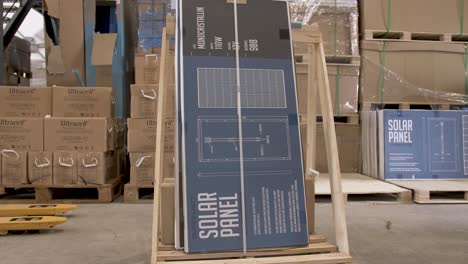 Solar-panel-of-110W-monocrystalline-placed-on-a-crate-before-shipping-at-a-solar-warehouse,-Orbit-around-shot