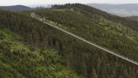 World's-longest-suspension-footbridge-in-czech-mountains,-drone-shot