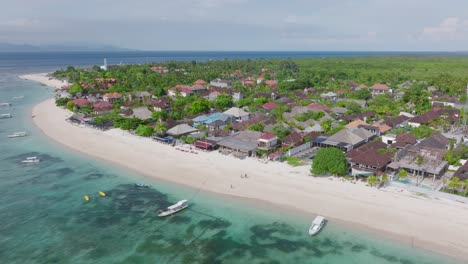 Tropical-tourist-destination-with-white-sand-beach-and-resorts-on-shore,-Pantai-Pasir-Putih,-aerial