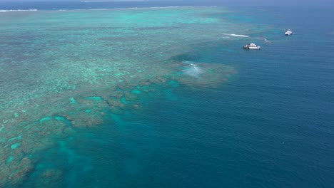Great-Barrier-Reef-landscape-aerial-of-coral-and-tourism-scuba-diving-boats,-near-Cairns,-Queensland,-Australia