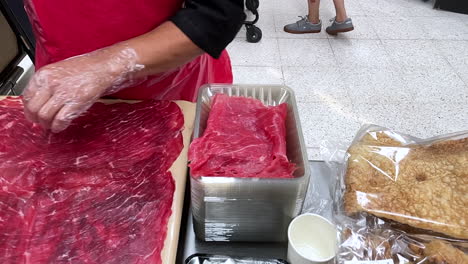 slow-motion-shot-of-meat-being-served-on-a-tray