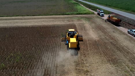 An-industrial-combine-harvester-collecting-soybean-crops-from-farmland-deforested-in-the-Brazilian-savannah---aerial-view