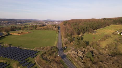 European-country-road-leading-past-a-large-solar-farm-in-Germany