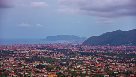 Overview-of-a-beach-town-of-Cefalù,-in-northern-Sicily-near-Palermo,-Italy-with-cloud-movement-in-timelapse-in-the-evening
