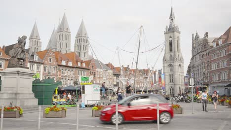 Old-Pottery-Market-In-Tournai,-Belgium-With-People-Jumping-On-Trampolines