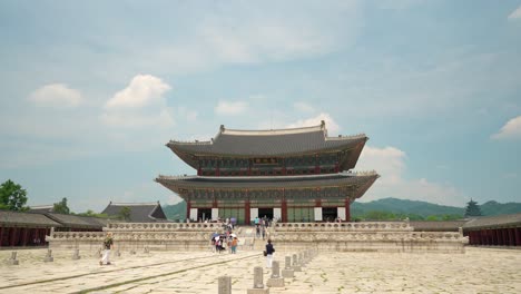 Groups-of-people-visiting-Gyeongbokgung-Palace-on-a-summer-cloudy-day---front-view