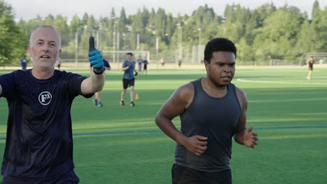 Mature-men-jogging-and-exercising-on-a-soccer-field