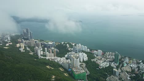 Drone-flying-forwards-revealing-Aberdeen-City-in-Hong-Kong,-flying-over-the-cloud