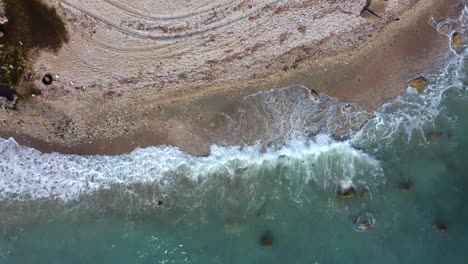 Drone-shot-of-the-Albanian-coast-in-the-Mediterranean-sea---drone-is-ascending-from-the-sand-of-a-lonely-beach