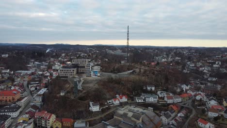 Floyheia-hill-with-famous-glass-elevator-and-radio-tower-in-Arendal-Norway---Slow-rotating-aerial