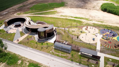 Flying-Over-a-Famous-Wooden-Brushwood-Mineral-Structure-on-a-Vast-Land-Park-in-Countryside-of-Warmia-and-Masuria-Region-Poland,-The-Lidzbark-Warminski-Graduation-Tower