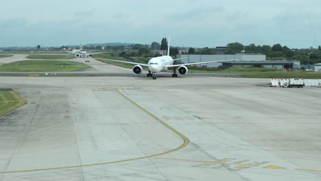 Air-France-jet-taxiing-on-tarmac-after-landing,-heading-towards-arrival-gate