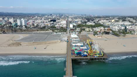 Beautiful-Blue-Sea-And-Amusement-Park-By-The-Beach-In-California---aerial-shot