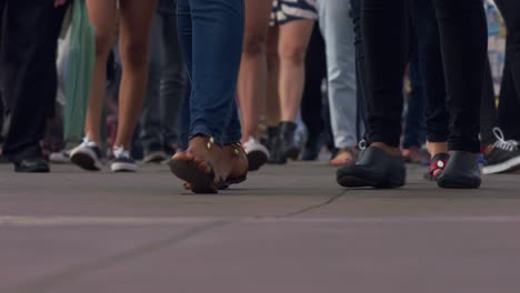 Busy-pedestrian-sidewalk-in-an-urban-environment---feet-and-legs-only-in-slow-motion