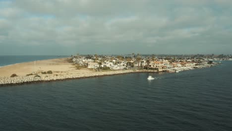 Beautiful-aerial-drone-of-California-coastal-beach-with-boats-in-the-harbor---Graded