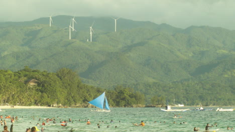 Nabas-windmills-tower-on-as-Boracay-tourists-below-enjoy-the-warm-day