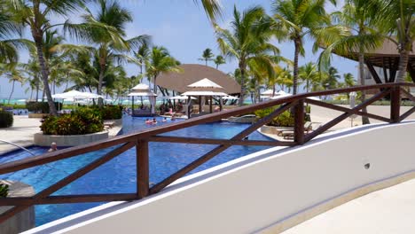 Rising-shot-from-bridge-looks-onto-pool-at-resort