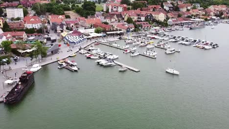 top-shot-aerial-bird-view-of-passenger-ships-and-private-yachts-in-the-harbor-of-Mikolajki-in-Poland-on-the-Mikolajskie-lake-in-holiday