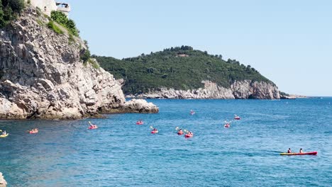 Turistas-En-Kayak-En-El-Mar-Cerca-Del-Casco-Antiguo-De-Dubrovnik,-Croacia