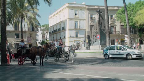 Horse-drawn-carriage-rides-take-tourists-sightseeing-in-Jerez,-Spain,-Slowmo