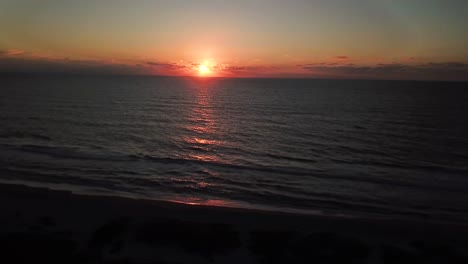 Aerial-drone-shot-of-the-sun-setting-on-the-gulf-of-mexico