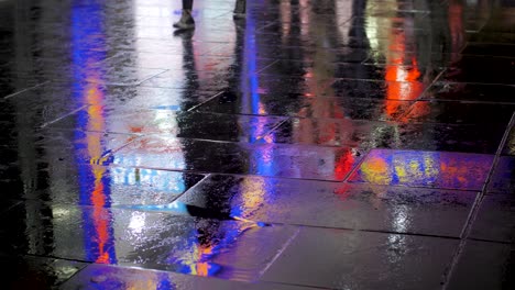 Colourful-city-light-view-reflections-on-water-during-rainy-day