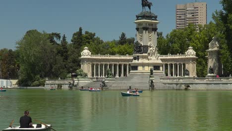 Slow-pan-down-over-boats-on-pond-in-Retiro-Park-in-Madrid