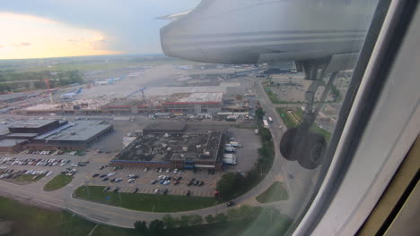 Plane-landing,-Aerial-airplane-window-view,-aircraft-window-view,-approaching-the-airport,-during-flight-plane-seat-view,-looking-through-the-window-moments-before-landing