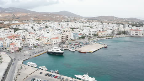 Drone-aerial-flight-over-bay-area-at-port-of-Tinos-in-Greece