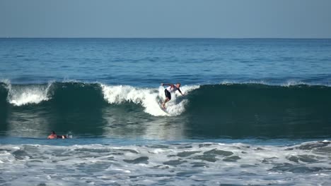 Surfers-enjoying-the-beautiful-waves-by-the-Santa-Teresa-Beach-in-Costa-Rica---Wide-shot