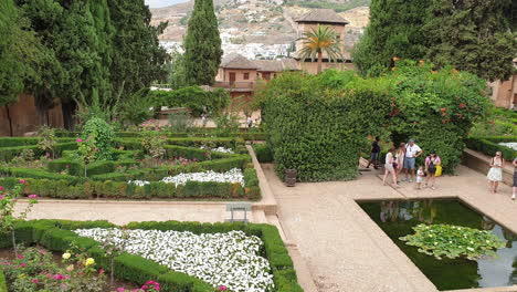 Tourists-visiting-gardens-of-portico-palace,-Alhambra,-Spain
