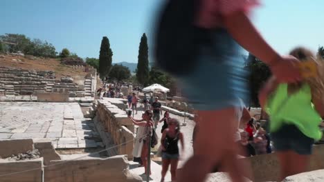 Tourist-groups-walking-around-territory-with-ruins-of-ancient-civilization-buildings-around-Athens
